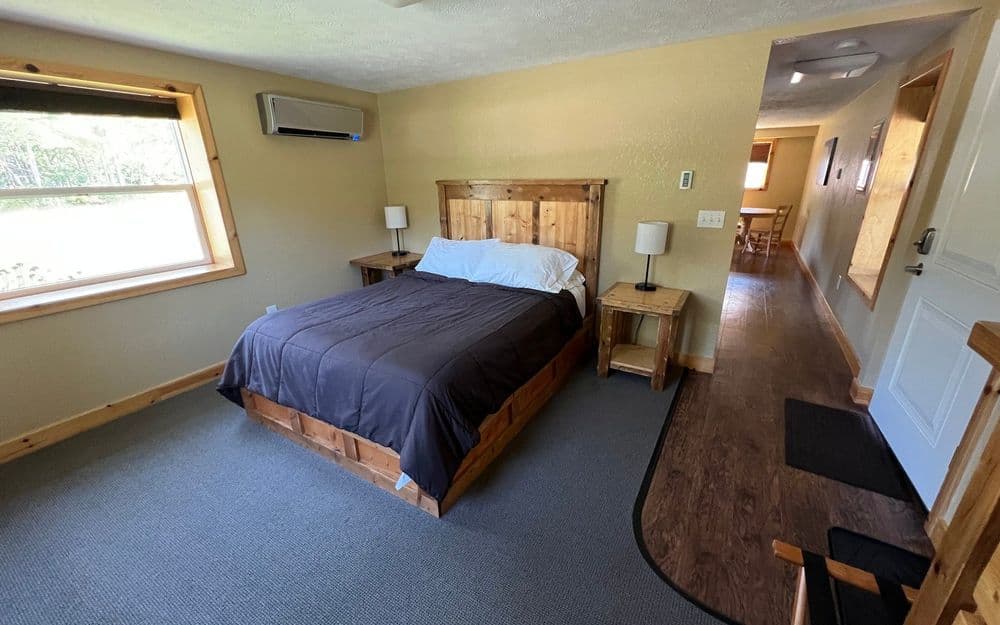 Queen Suite bedroom with a made queen bed