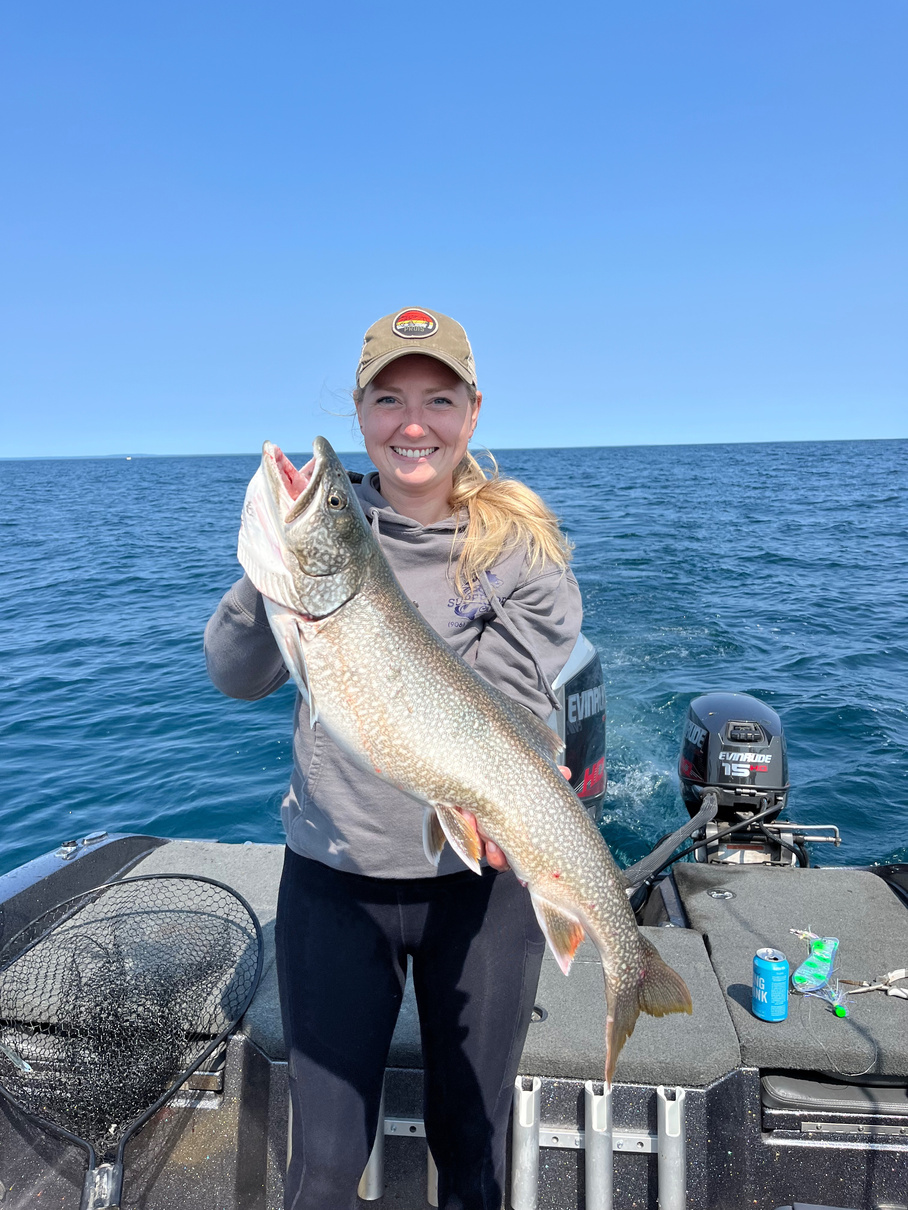 Fishing on Lake Superior whitefish point Paradise Michigan Captain women holding trophy lake trout Superior Charters fishing 